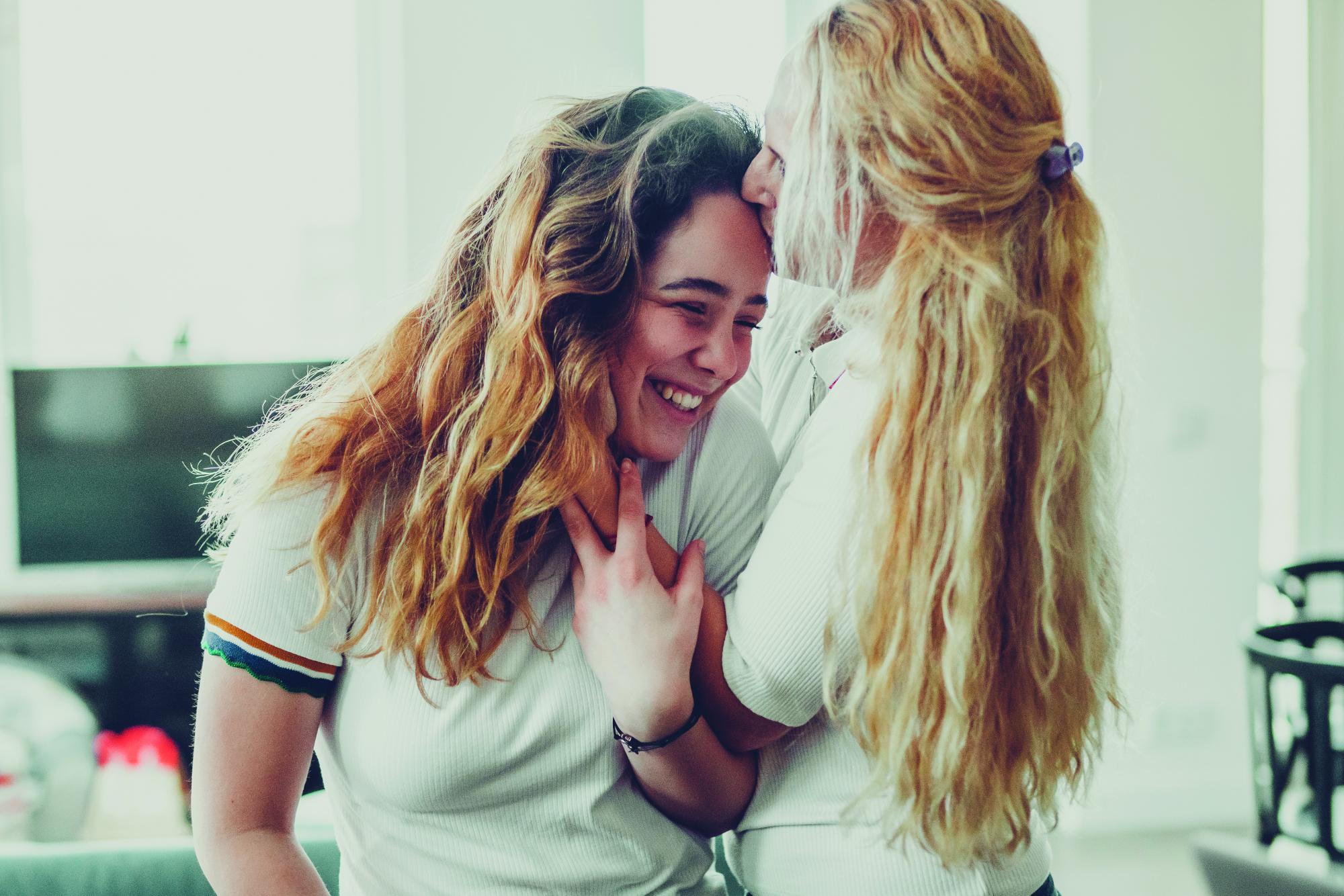 Daughter kissing mom